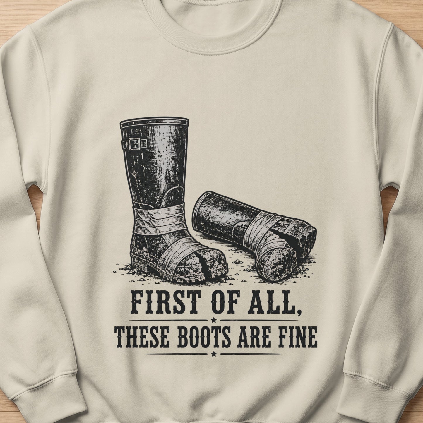 Illustration of dirty boots on sweatshirt with text "FIRST OF ALL, THESE BOOTS ARE FINE".