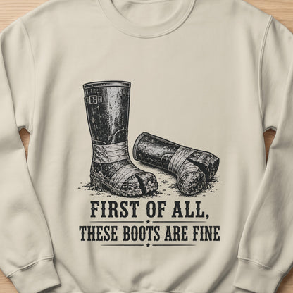 Illustration of dirty boots on sweatshirt with text "FIRST OF ALL, THESE BOOTS ARE FINE".