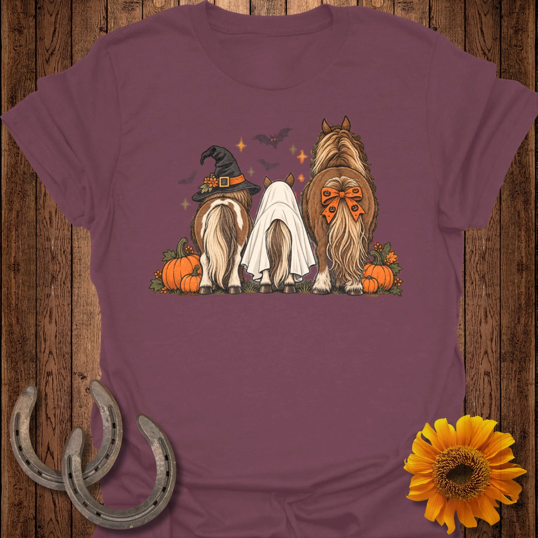 Three horses with Halloween costumes, pumpkins, and bats.
