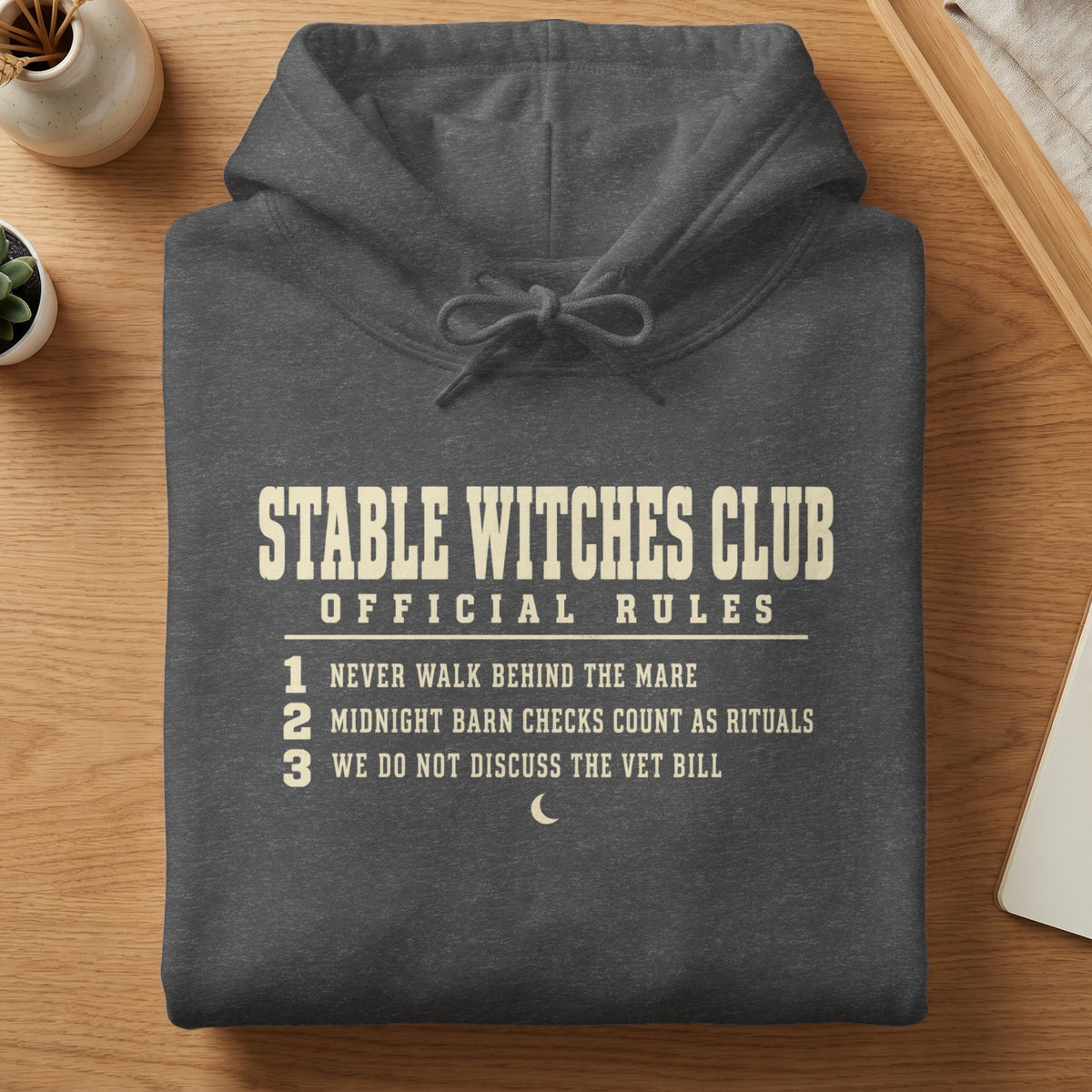 Dark grey hoodie with "Stable Witches Club Official Rules" and three numbered rules.