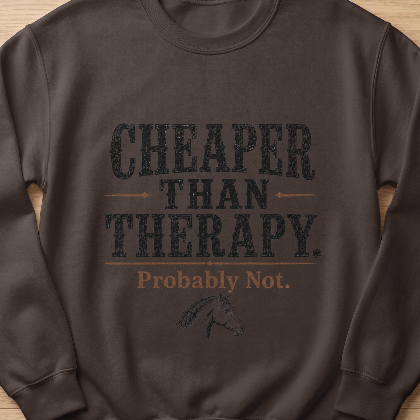 Dark brown sweatshirt with "Cheaper Than Therapy. Probably Not." text and horse graphic.