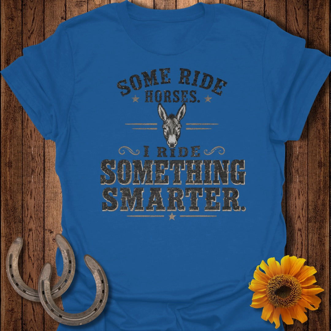 Blue shirt with text "Some Ride Horses. I Ride Something Smarter." and donkey graphic.