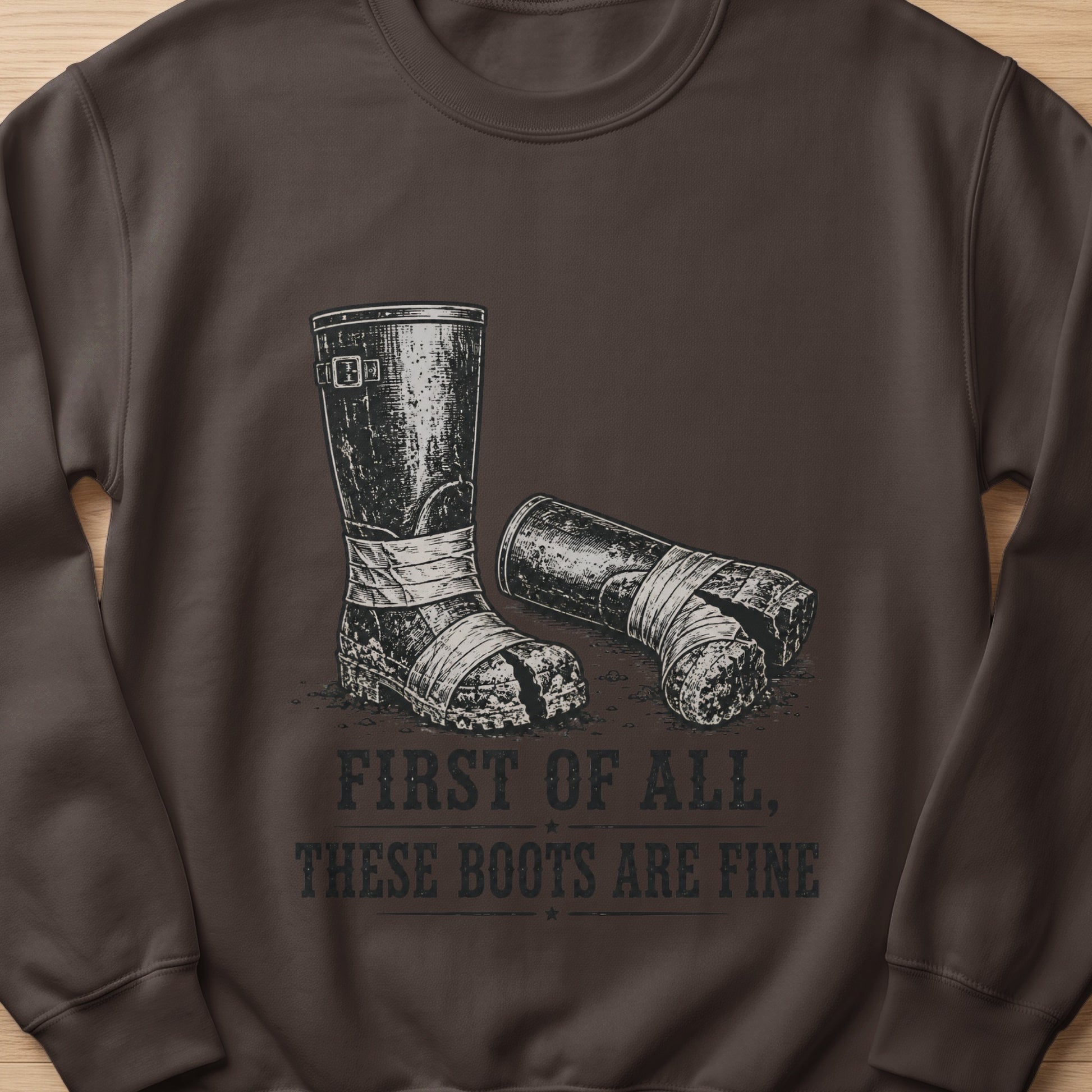 Dark brown sweatshirt with a graphic of two distressed boots and text.