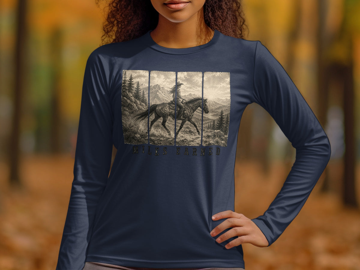 Long-sleeve shirt with a vintage graphic of a person riding a horse through mountains, text reads "MILES EARNED".
