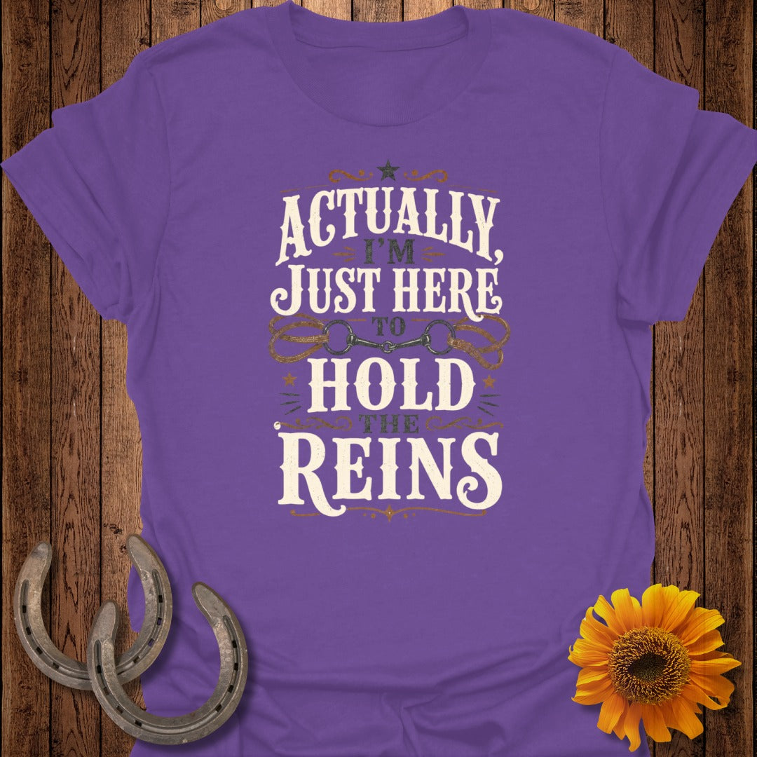 Purple t-shirt with text "Actually I'm Just Here To Hold The Reins" and horse bit graphic.