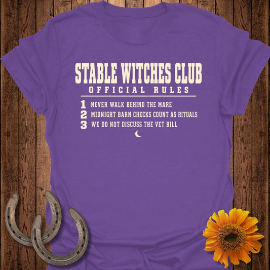 Purple t-shirt with "Stable Witches Club Official Rules" and three numbered rules.