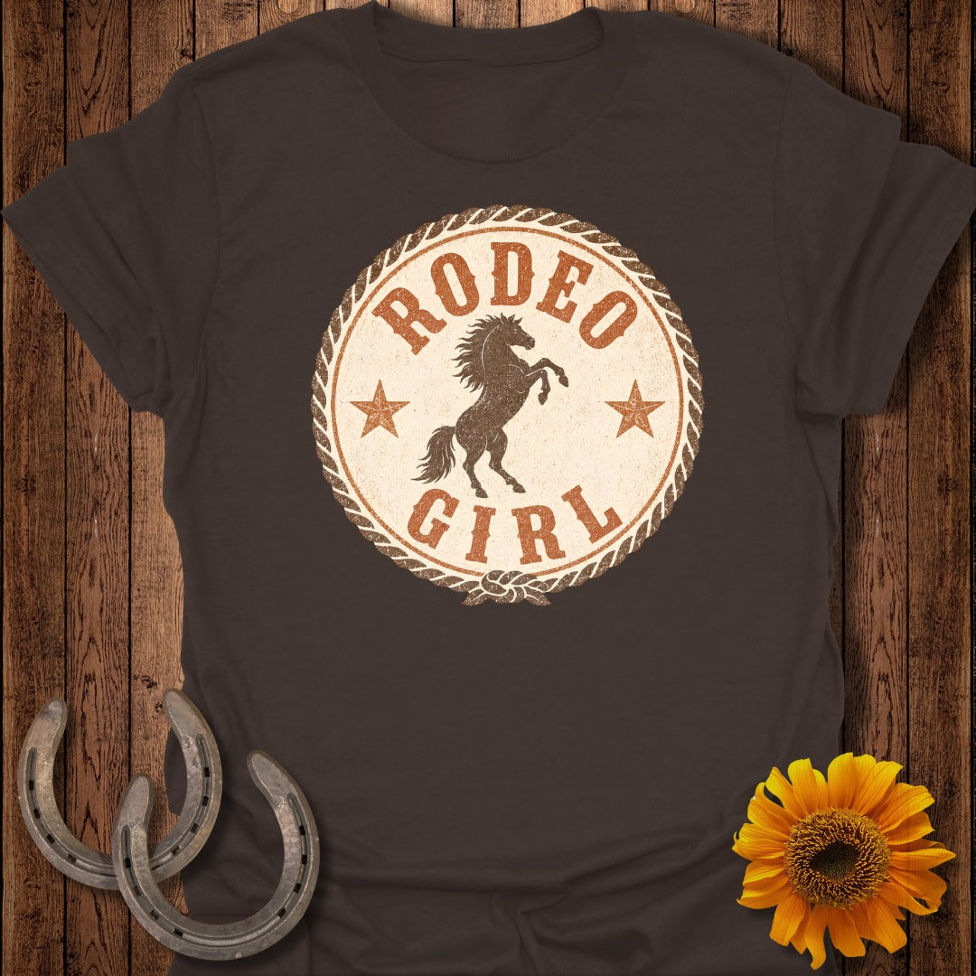 Brown t-shirt with distressed "Rodeo Girl" circular logo featuring a bucking horse.