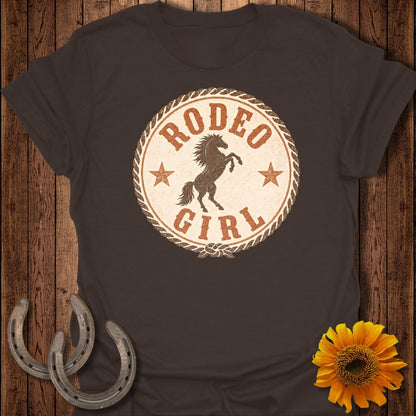 Brown t-shirt with distressed "Rodeo Girl" circular logo featuring a bucking horse.