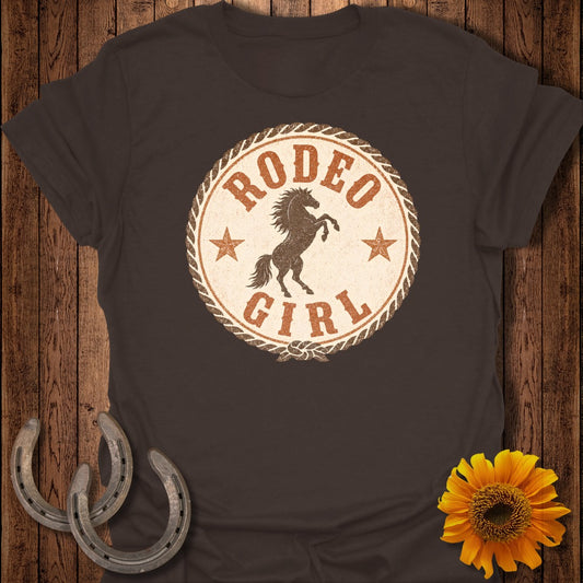 Brown t-shirt with distressed "Rodeo Girl" circular logo featuring a bucking horse.