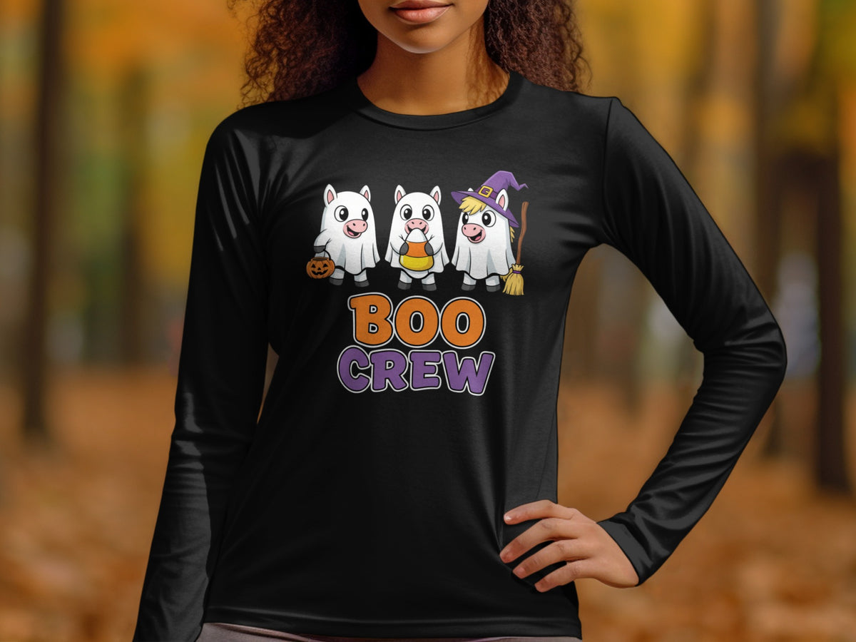 Three white pigs in ghost costumes, one holding candy corn, with text "BOO CREW".