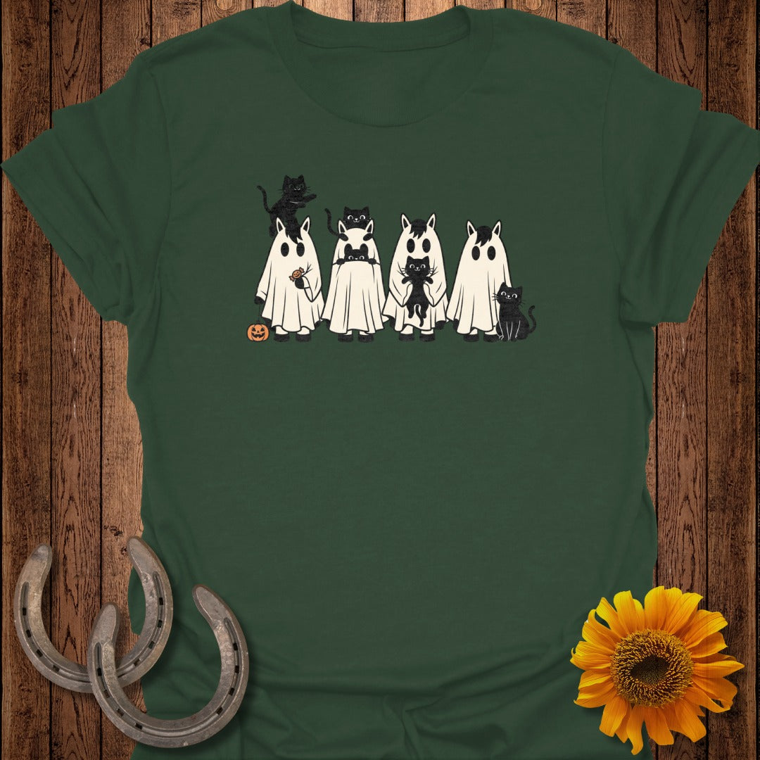 Black cats in ghost costumes with a pumpkin, on a green t-shirt.