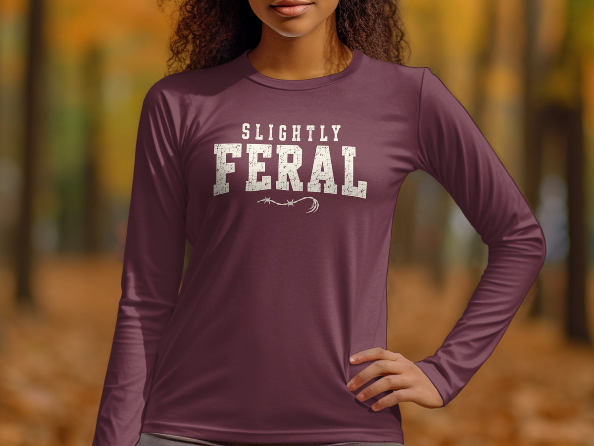 Woman wearing maroon long-sleeve shirt with "SLIGHTLY FERAL" text.