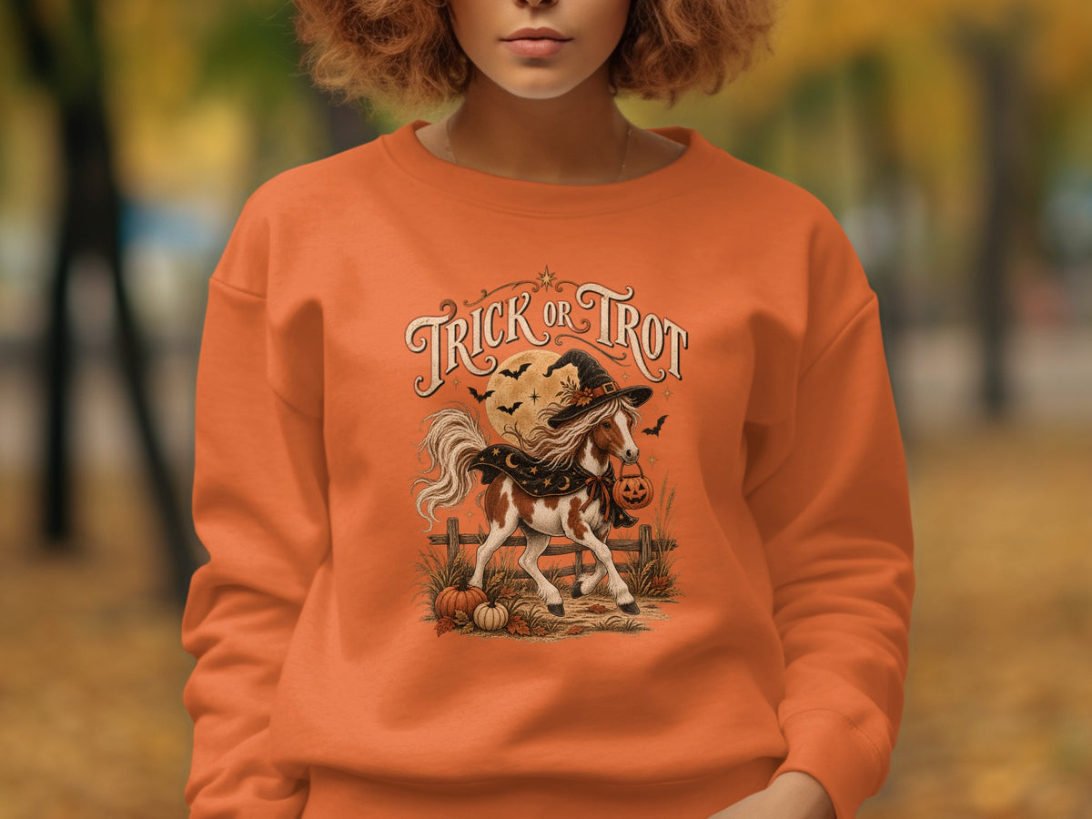 Orange sweatshirt with "Trick or Trot" text, a horse in a witch hat and cape, and pumpkins.