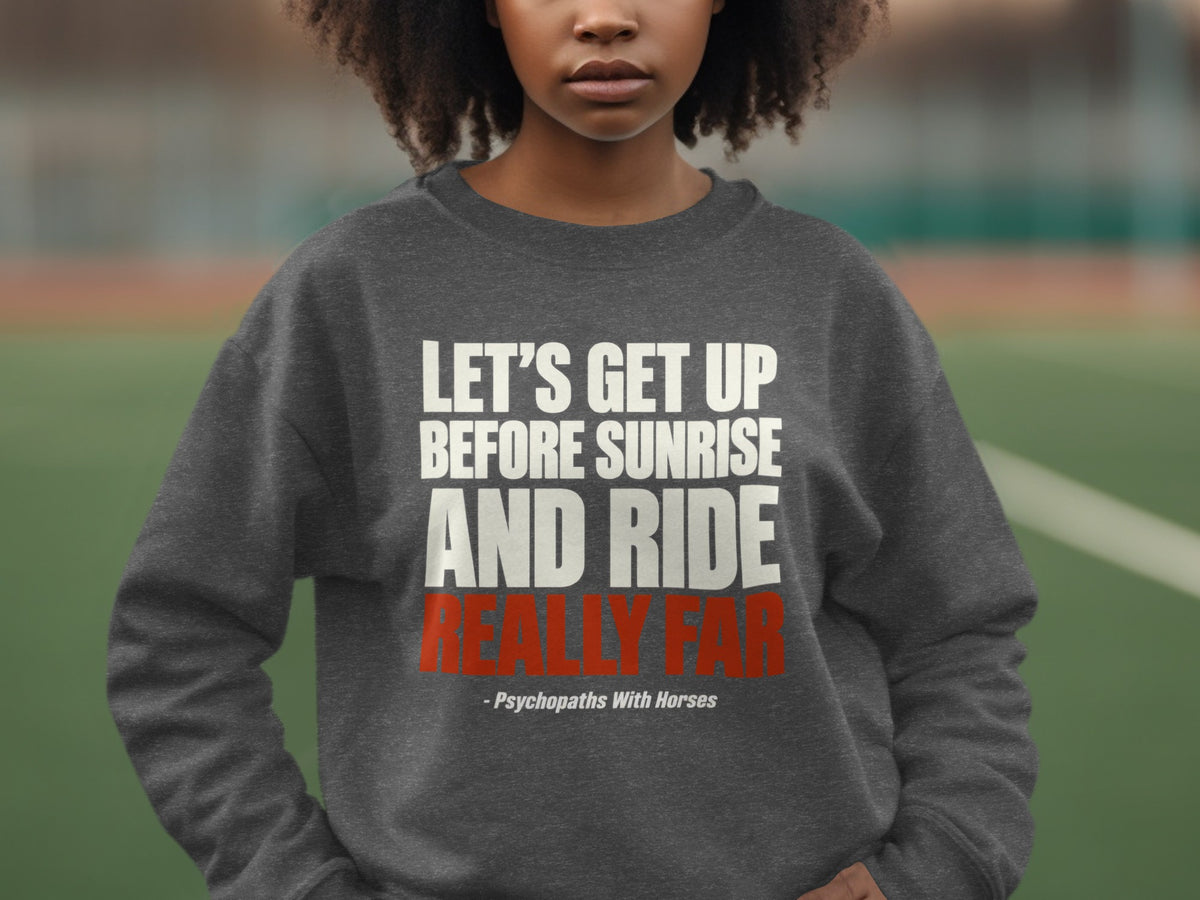 A person wearing a dark grey crewneck sweatshirt featuring white and red printed text.