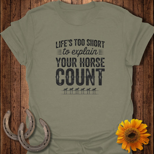 Olive green t-shirt with "Life's Too Short to Explain Your Horse Count" text and horse icons.