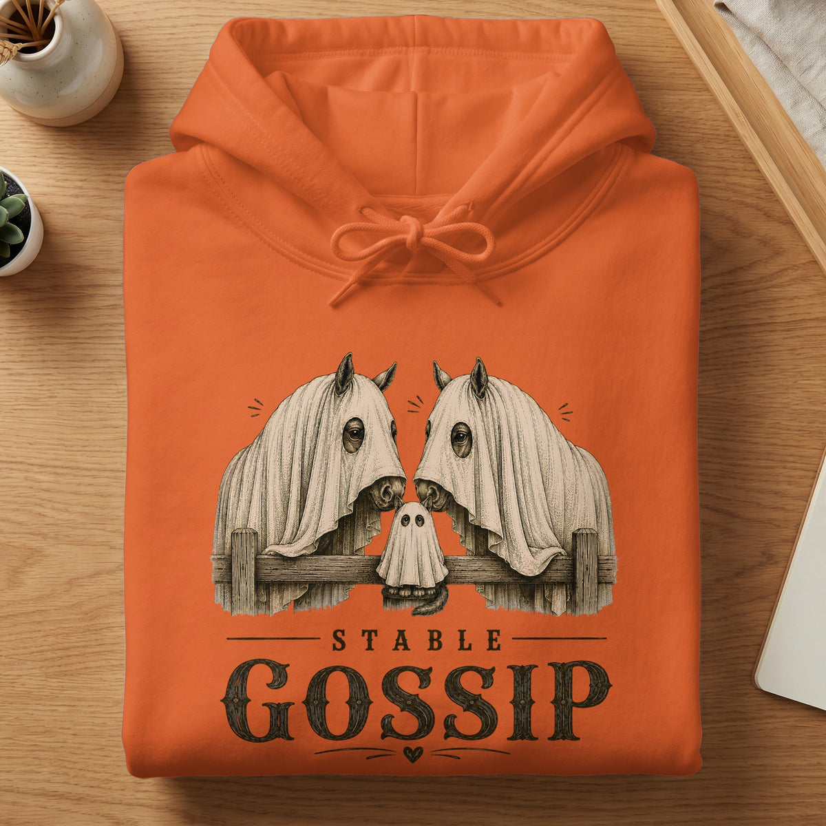 Orange hoodie with vintage graphic of horses and ghost, text says "Stable Gossip".