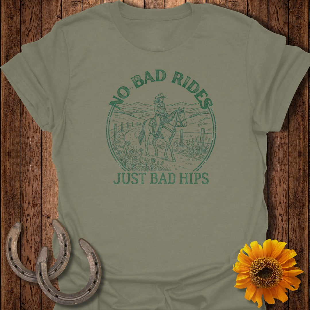 Green graphic tee with a horseback rider and the text "NO BAD RIDES JUST BAD HIPS".