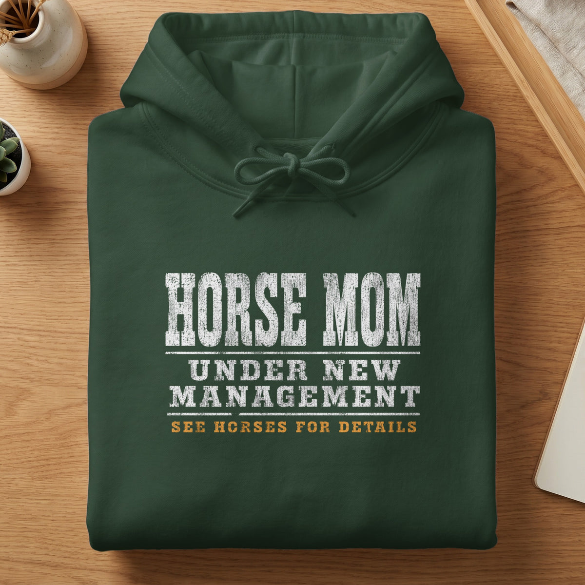 Dark green hoodie with "HORSE MOM UNDER NEW MANAGEMENT SEE HORSES FOR DETAILS" text.
