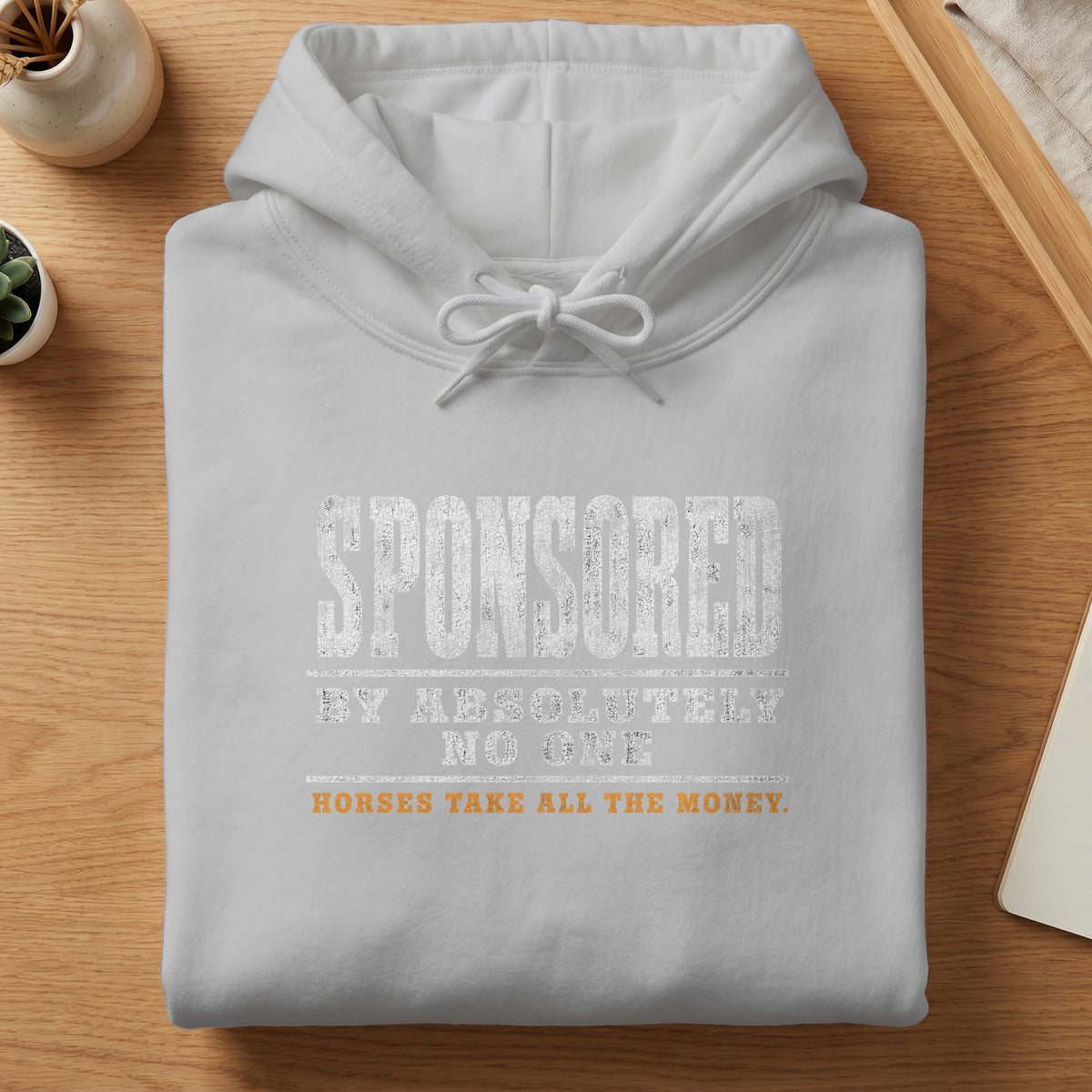 Light grey hoodie with white text "SPONSORED BY ABSOLUTELY NO ONE HORSES TAKE ALL THE MONEY."