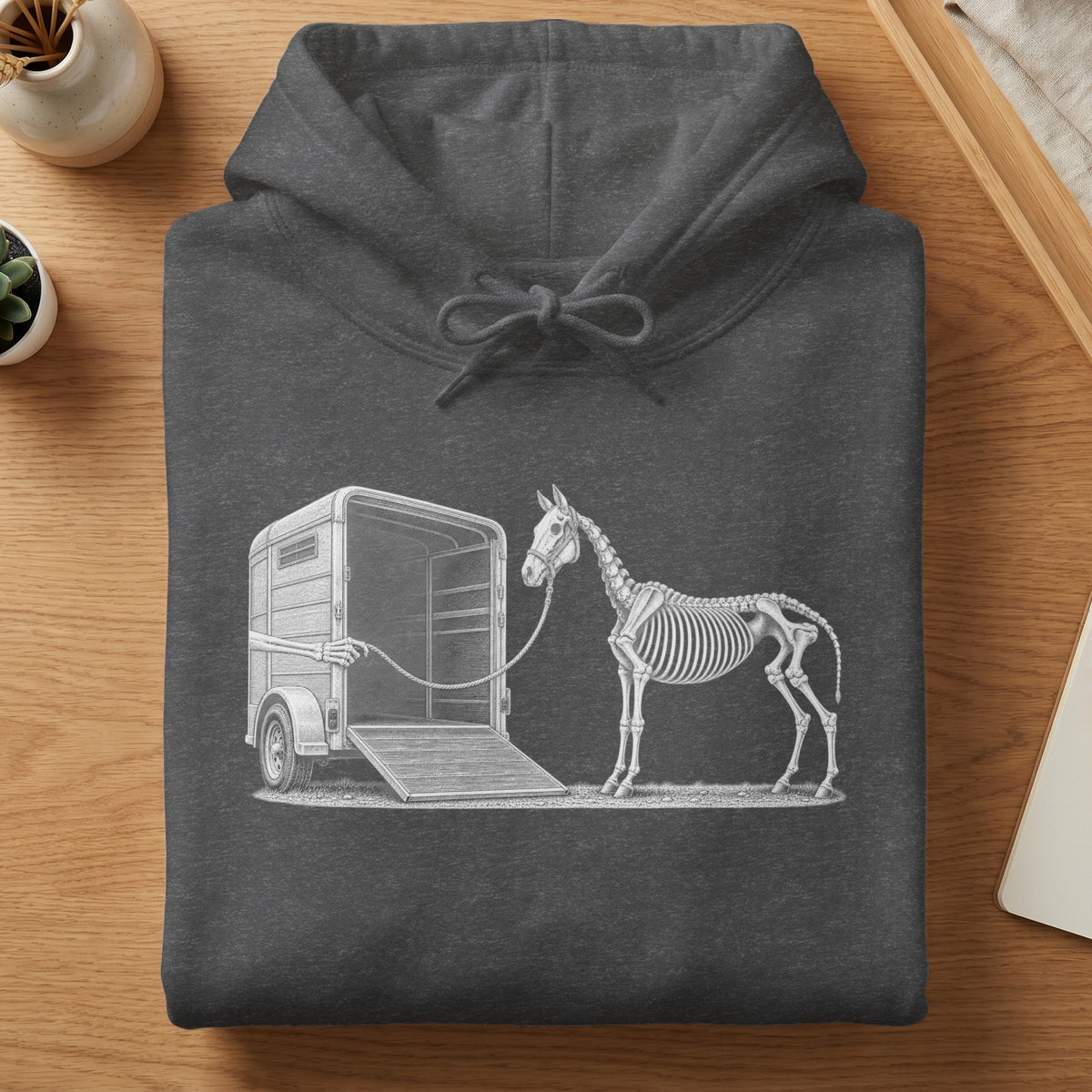Skeleton horse being led by a skeleton hand into a horse trailer.