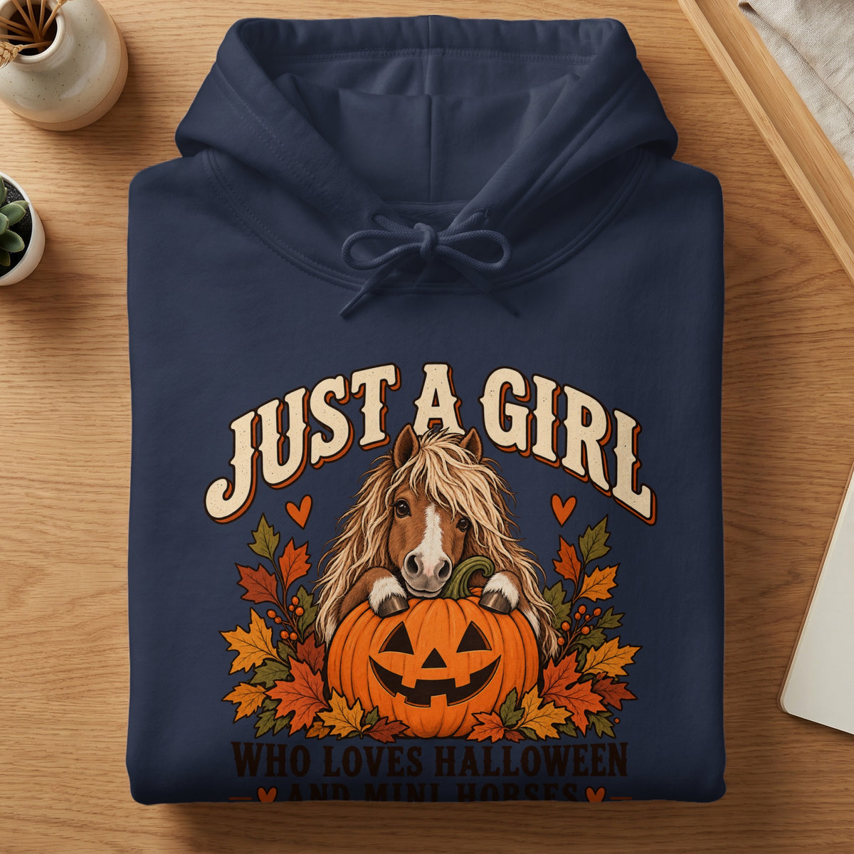 Navy hoodie with a horse, pumpkin, and fall leaves graphic reading "Just a girl who loves Halloween and mini horses."