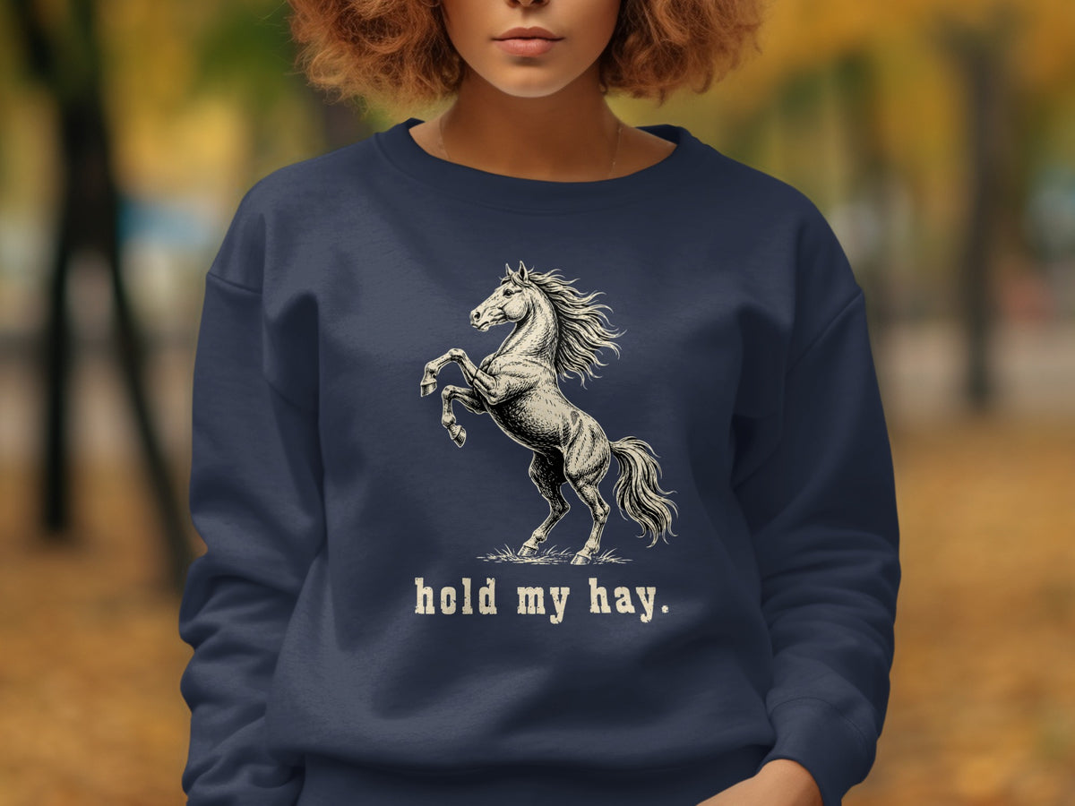 Navy sweatshirt with a rearing horse graphic and the text "hold my hay."