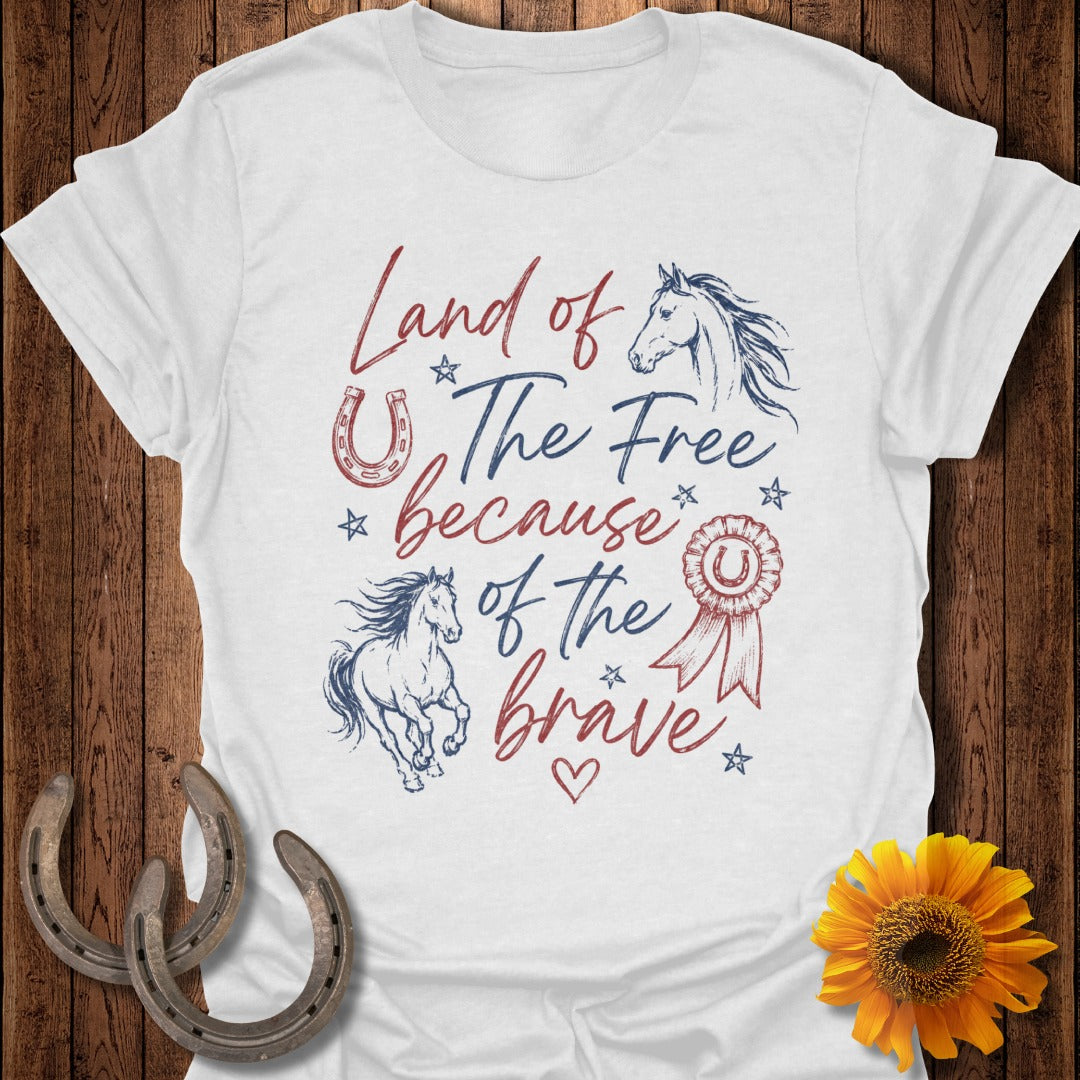 White t-shirt with "Land of the Free because of the Brave" text and horse graphics.