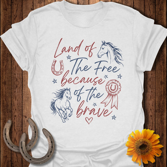White t-shirt with "Land of the Free because of the Brave" text and horse graphics.