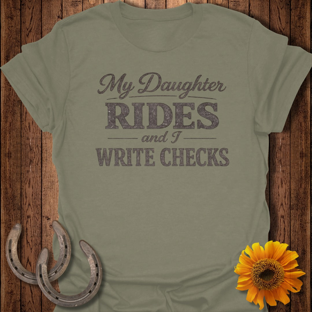 Olive t-shirt with "My Daughter Rides and I Write Checks" text, horseshoes, and sunflower.