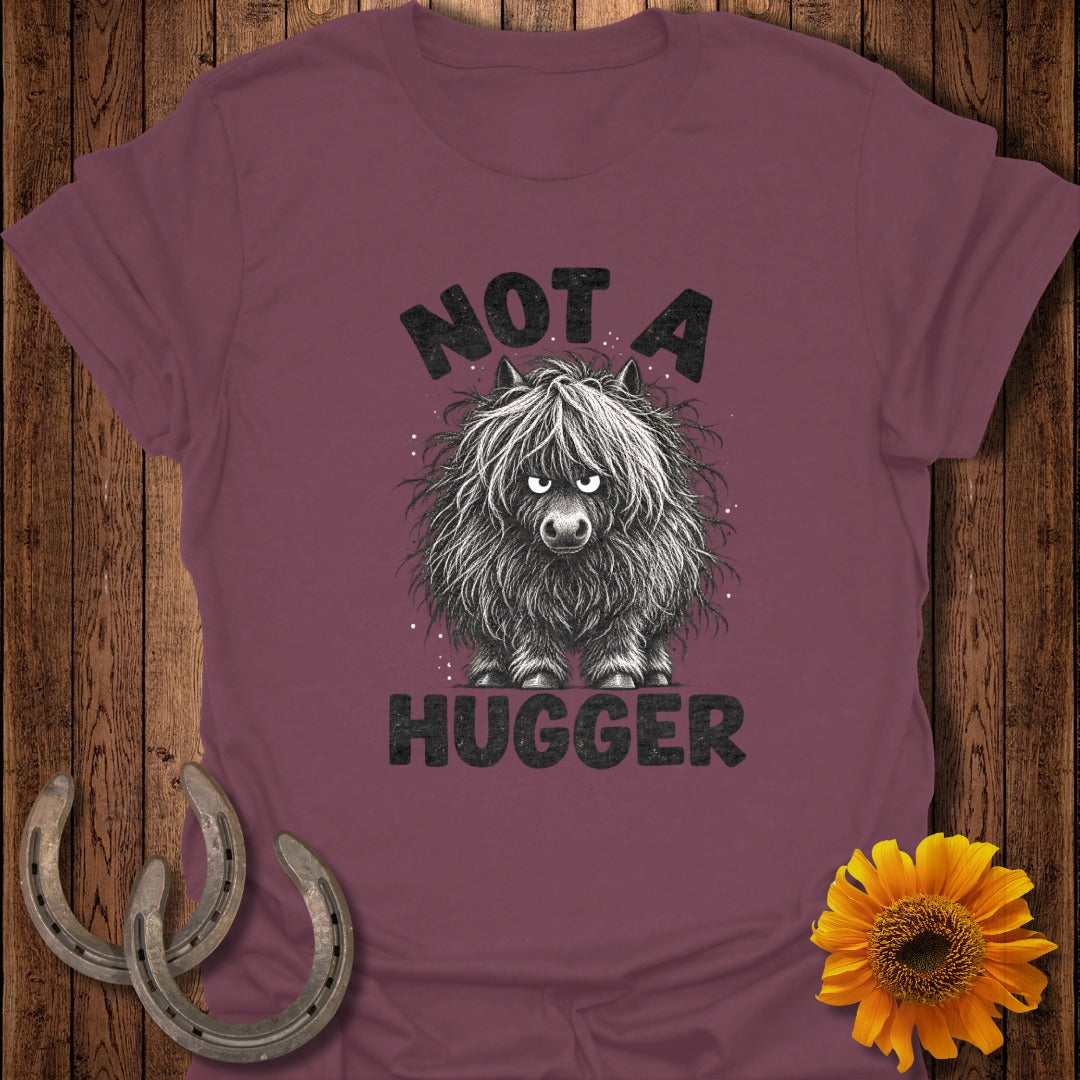 Maroon t-shirt featuring a grumpy, shaggy pony graphic with the text Not a Hugger.