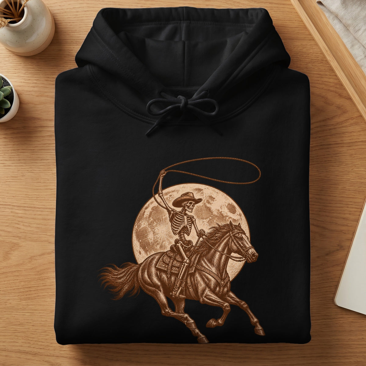 Black hoodie with skeleton cowboy on horse and moon graphic.