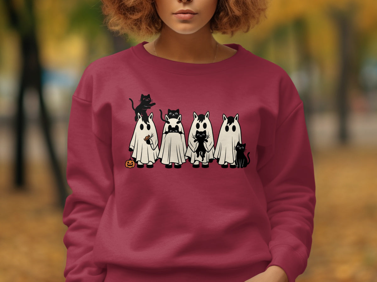 Crewneck sweatshirt with cartoon ghosts and black cats, featuring a pumpkin and candy.