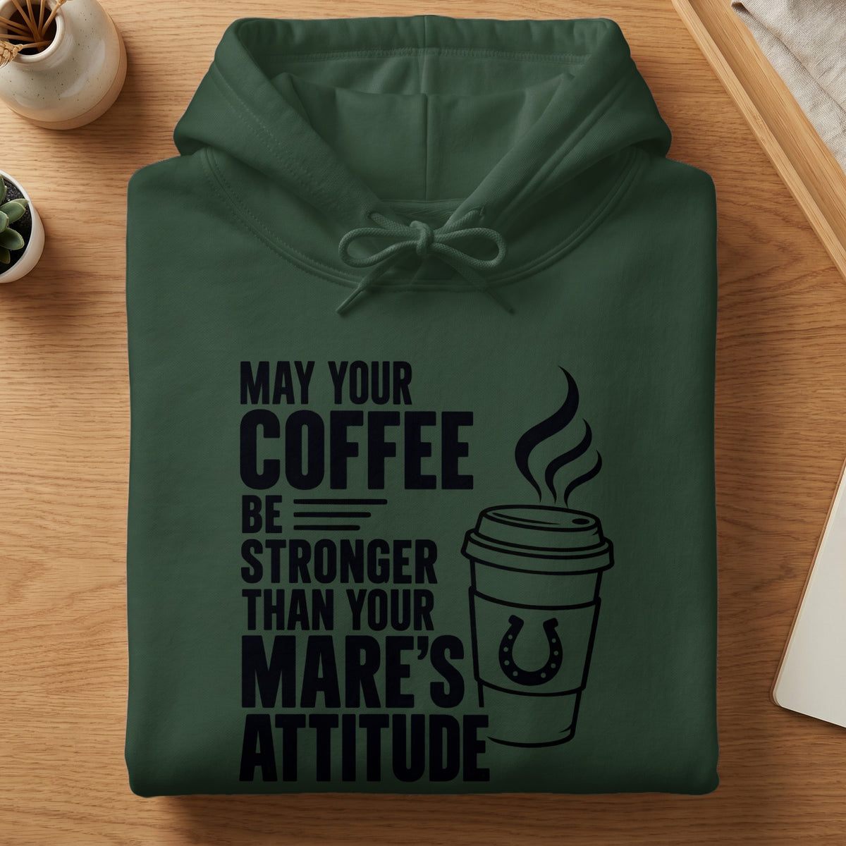 Dark green hoodie with "May your coffee be stronger than your mare's attitude" text.