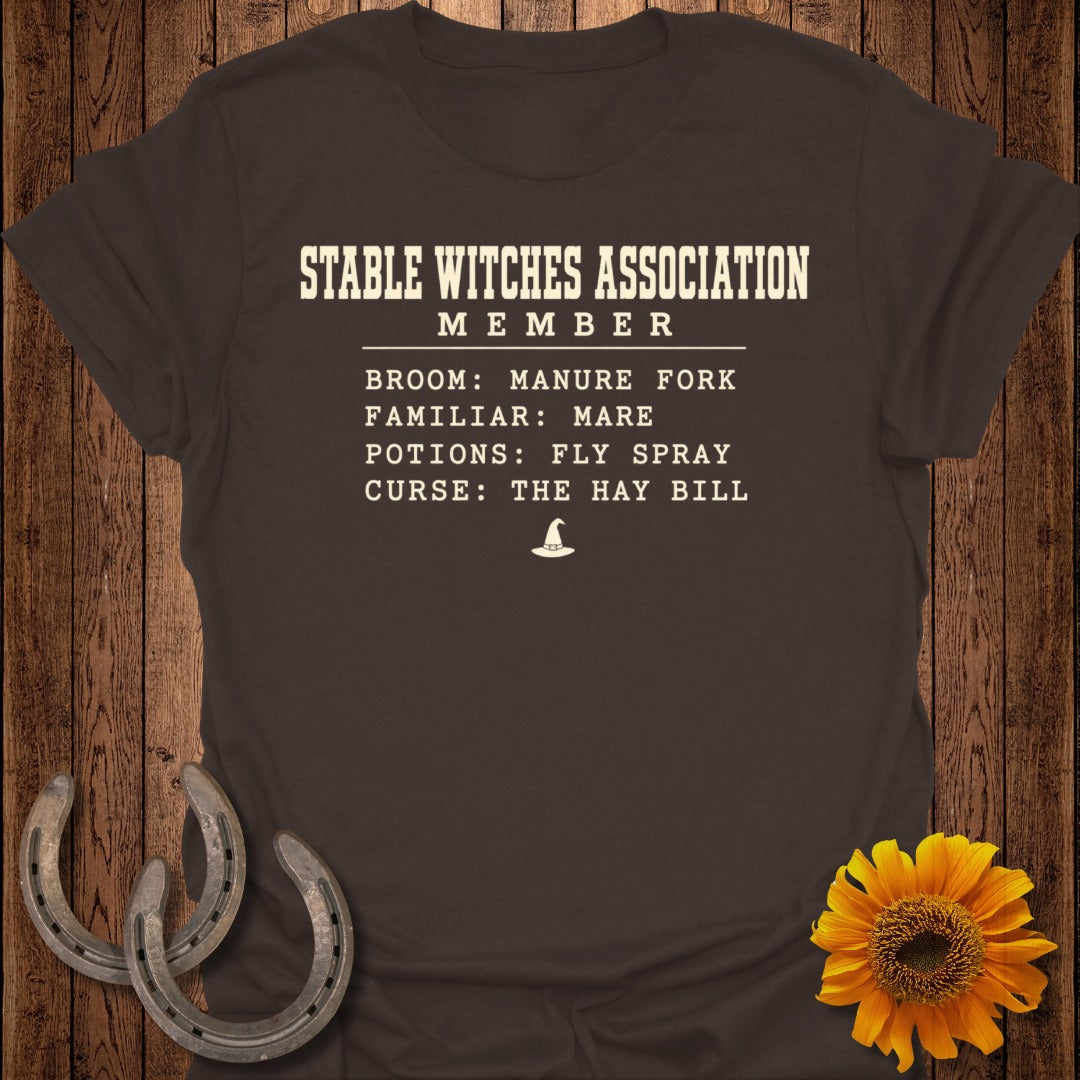 T-shirt with "Stable Witches Association Member" text and witch hat graphic.