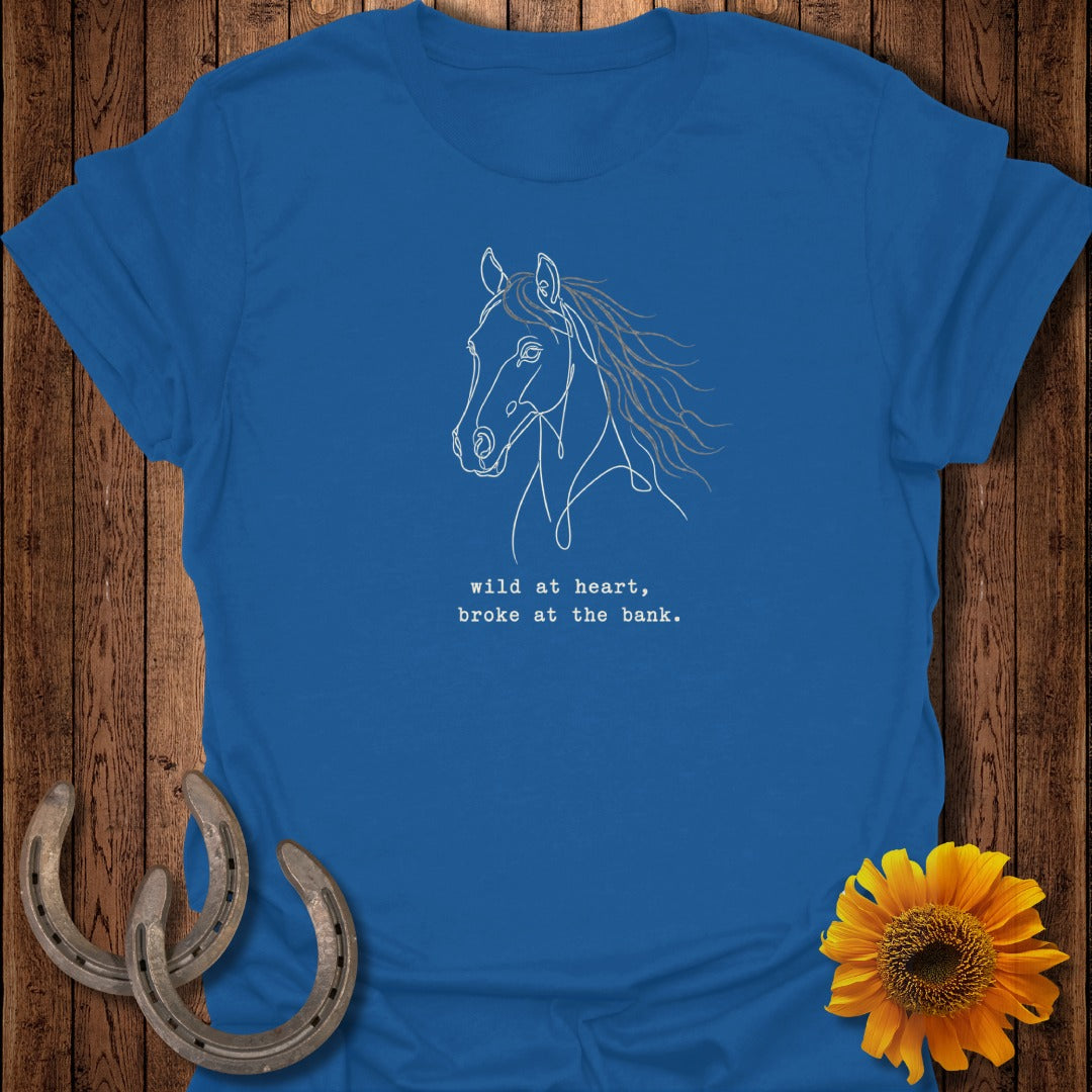 Royal blue t-shirt with white line drawing of a horse and text: "wild at heart, broke at the bank."