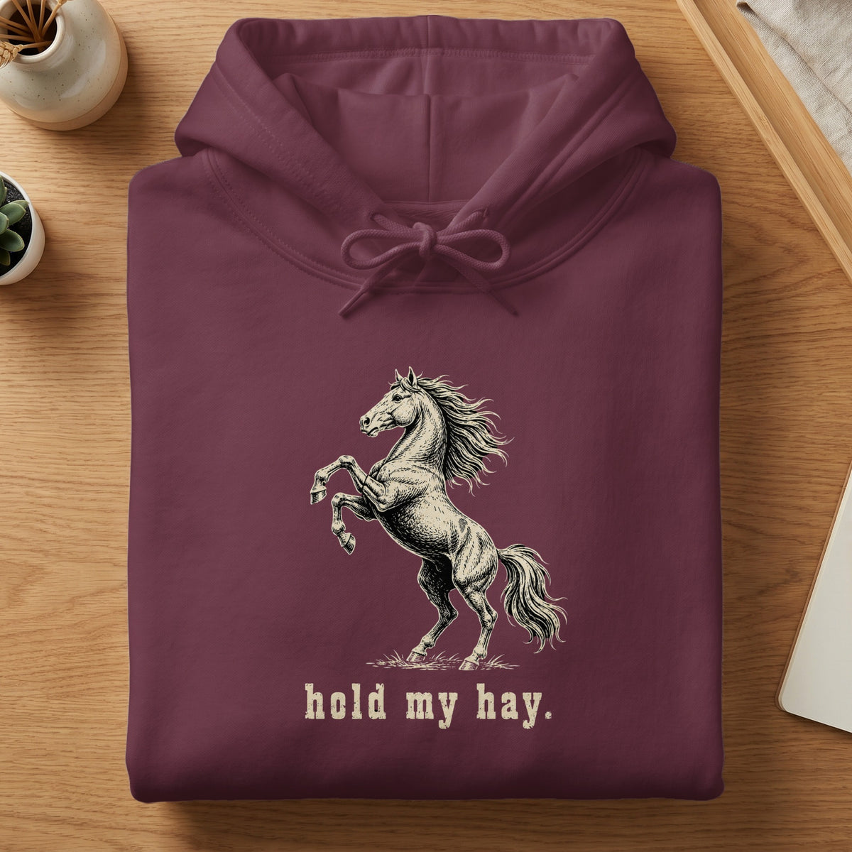 Maroon hoodie with a rearing horse graphic and "hold my hay." text.