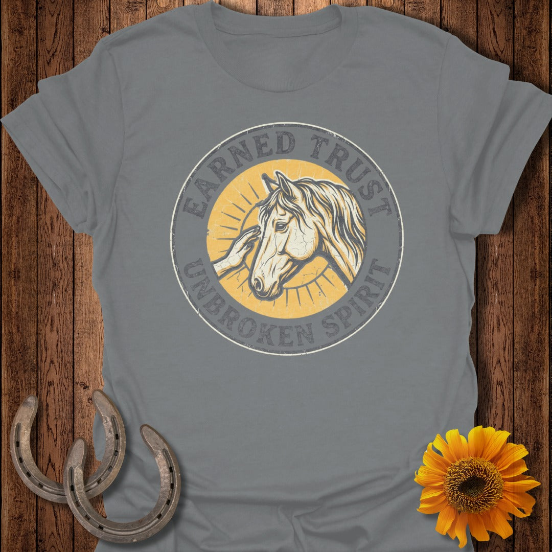 Gray t-shirt with "Earned Trust Unbroken Spirit" and a horse and hand graphic.