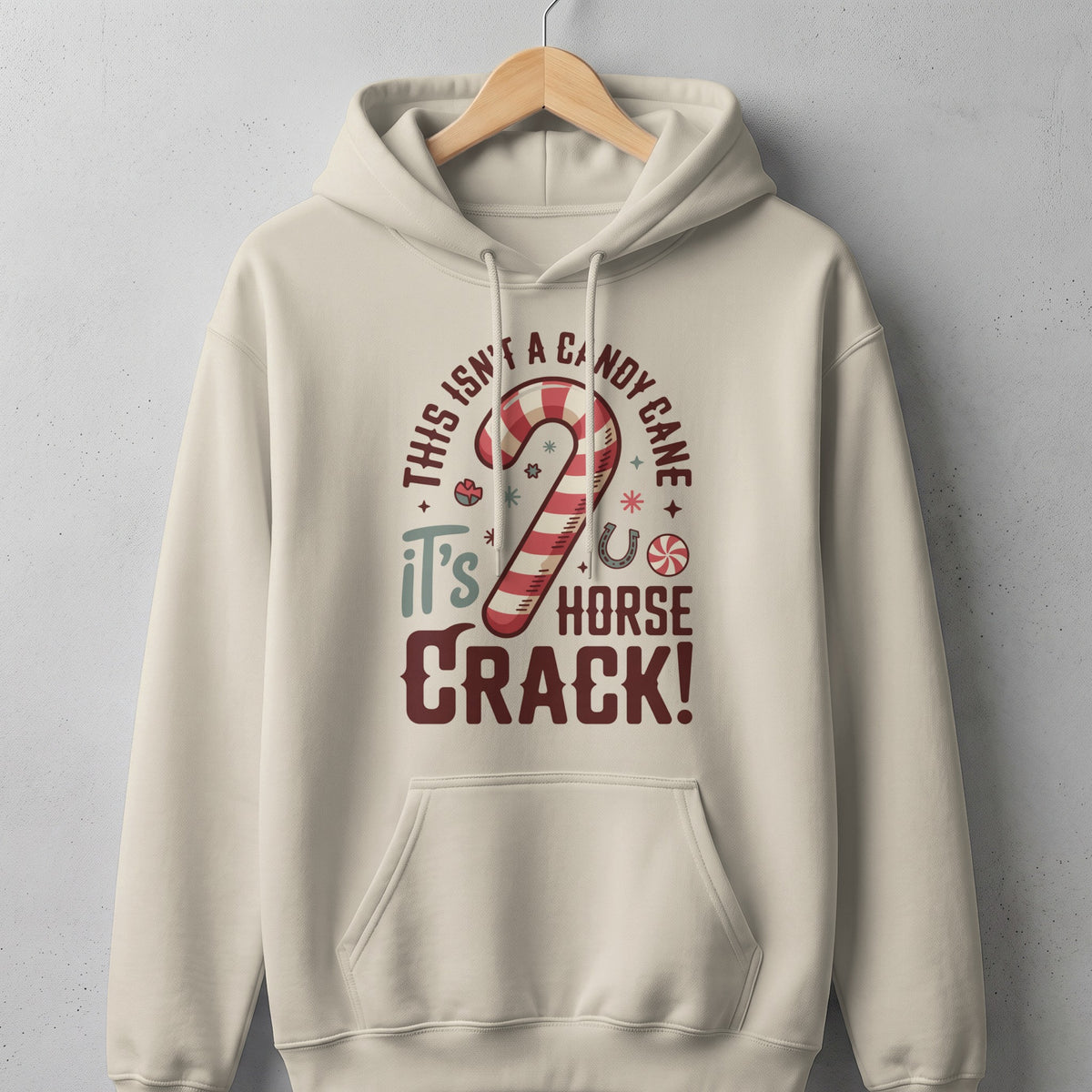 Cream hoodie with a candy cane and horse crack graphic.