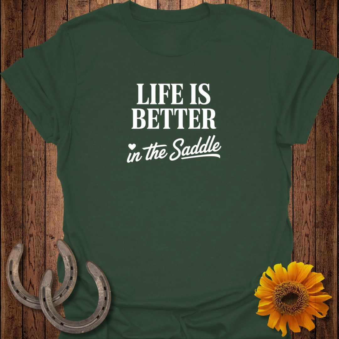 Green t-shirt with "LIFE IS BETTER in the Saddle" text and horseshoes.