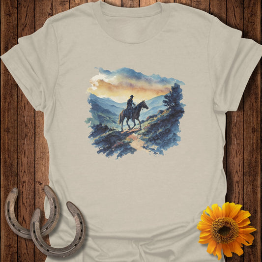 Watercolor painting of a cowboy on horseback on a mountain trail.