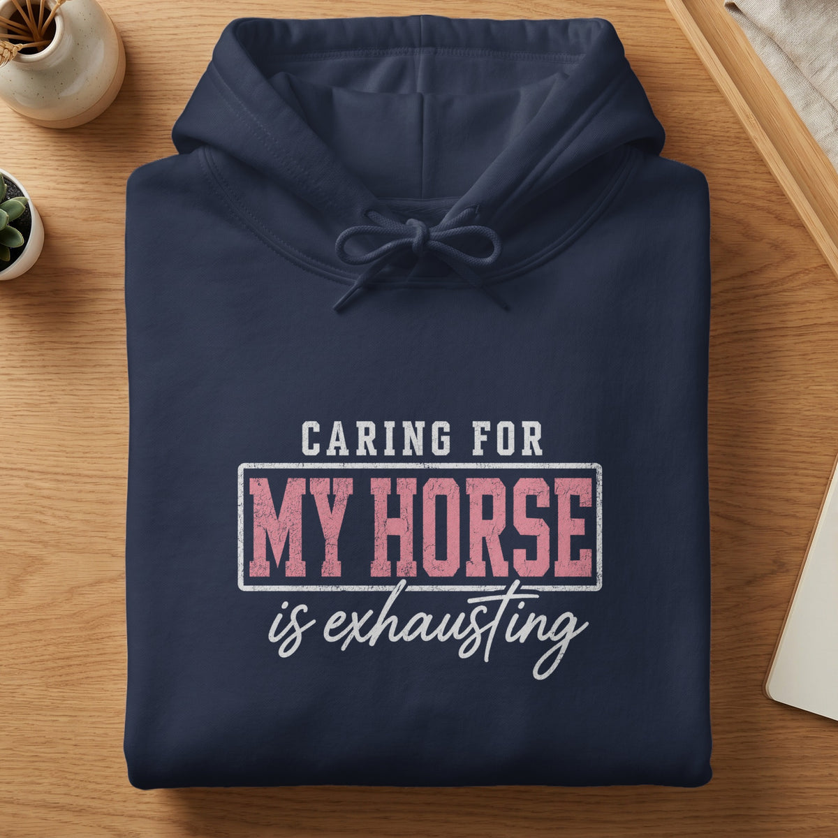 Navy blue hoodie with text "Caring for my horse is exhausting."