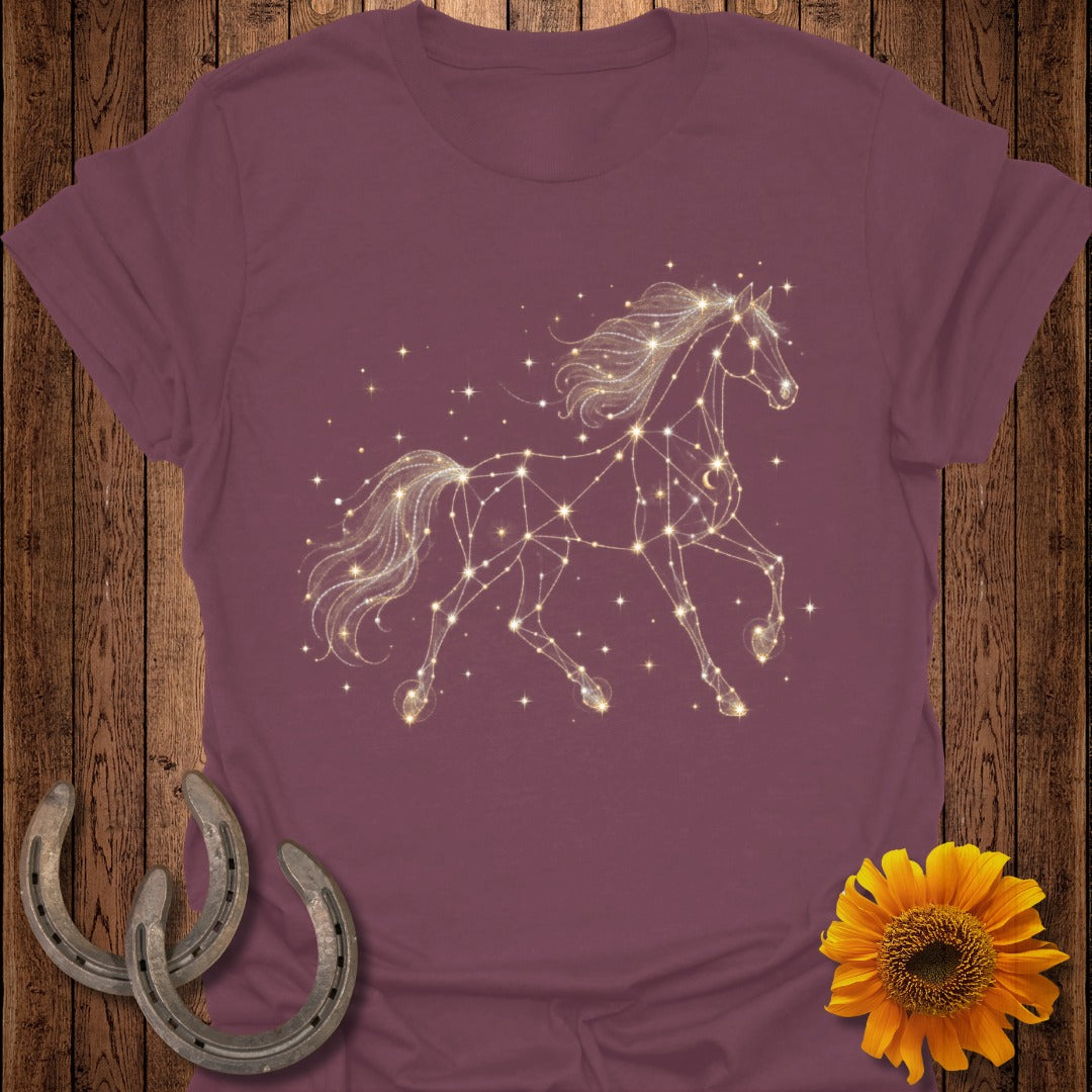 Maroon t-shirt with a glowing constellation horse graphic and stars.