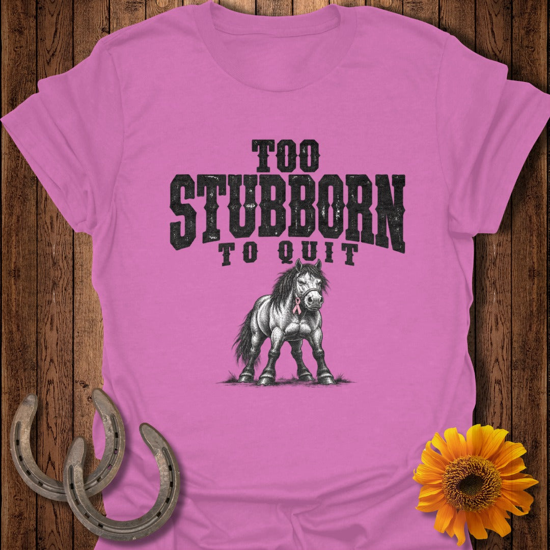 Pink t-shirt with black text "TOO STUBBORN TO QUIT" and a sketched horse.