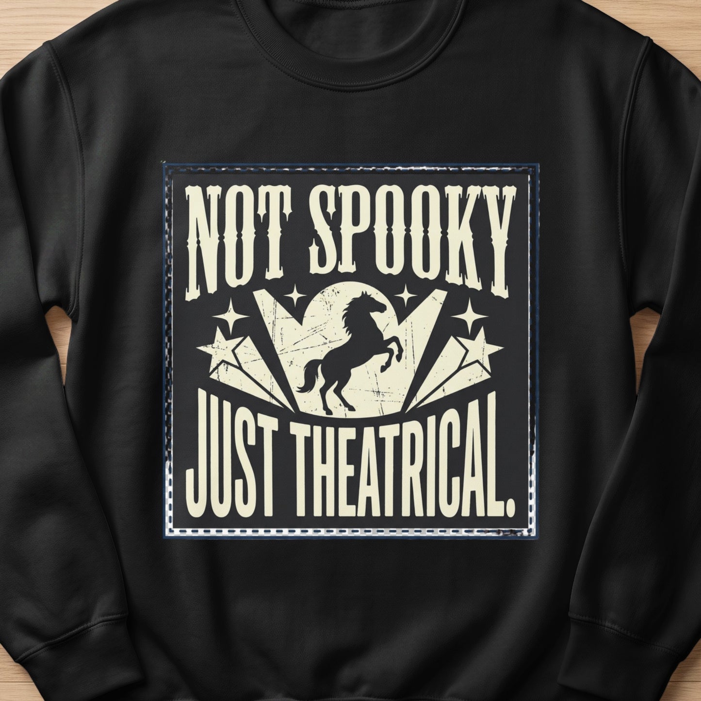 Black sweatshirt with "Not Spooky Just Theatrical" text and a horse silhouette.