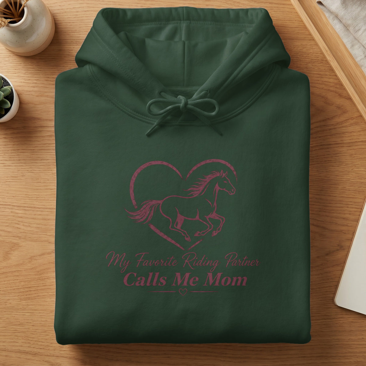Dark green hoodie with horse inside heart graphic and text "My Favorite Riding Partner Calls Me Mom."
