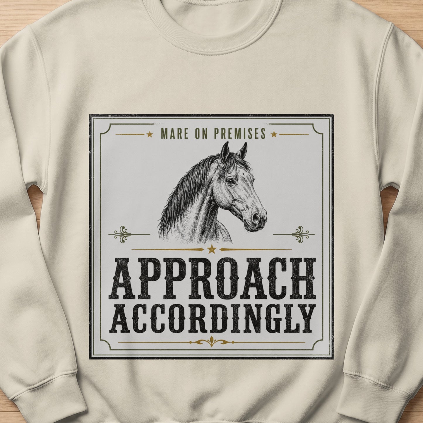 Cream sweatshirt with a black and white graphic of a horse and text.