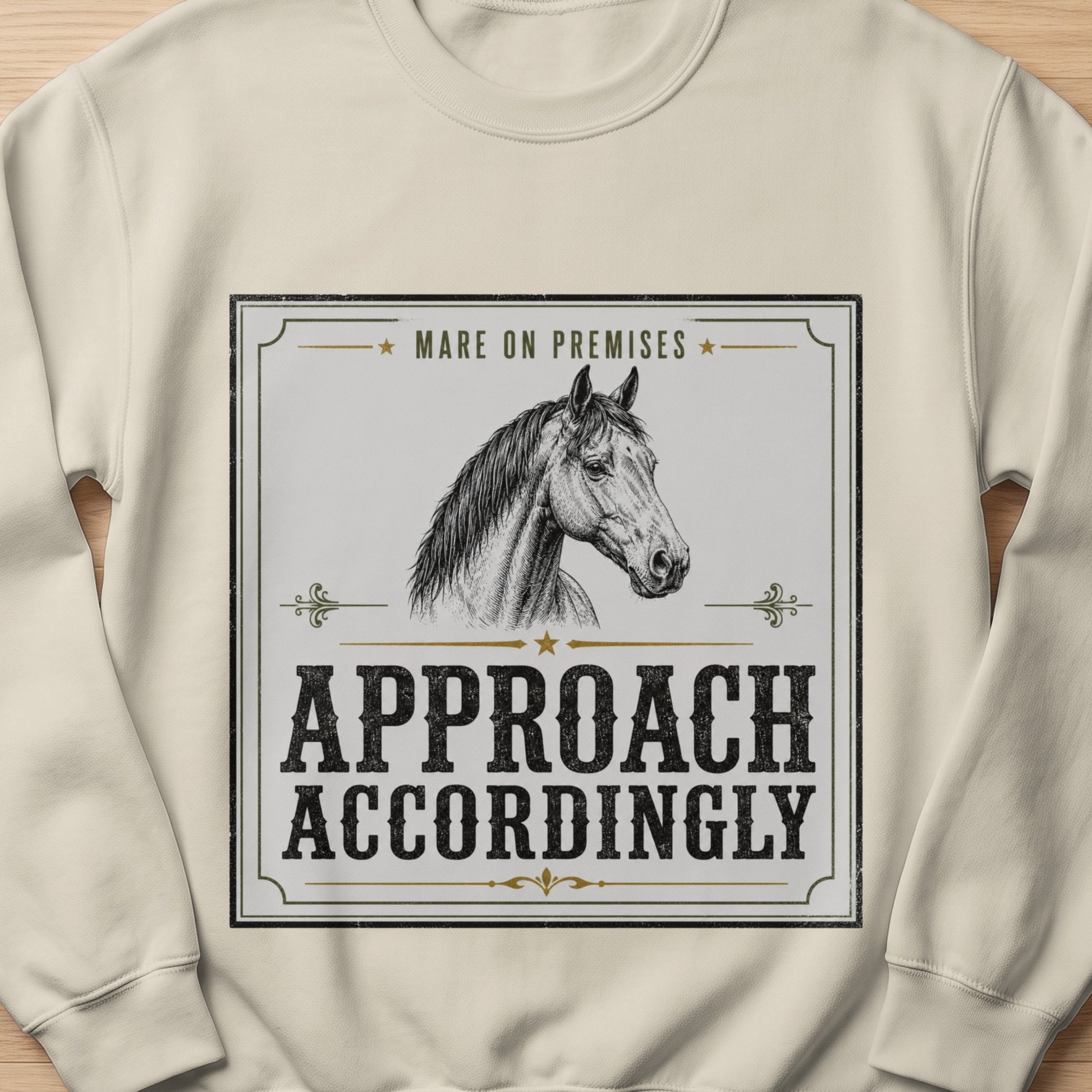 Cream sweatshirt with a black and white graphic of a horse and text.