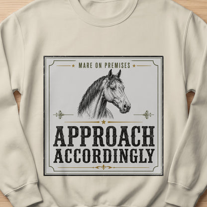 Cream sweatshirt with a black and white graphic of a horse and text.