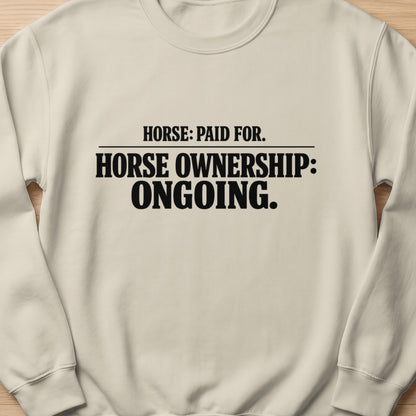 Cream sweatshirt with black text: Horse: Paid For. Horse Ownership: Ongoing.