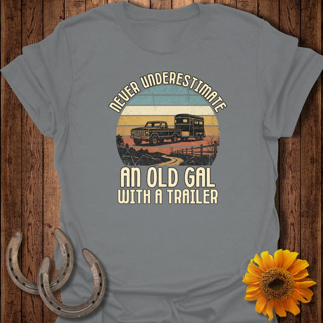 Grey t-shirt with "Never Underestimate An Old Gal With A Trailer" text and graphic.
